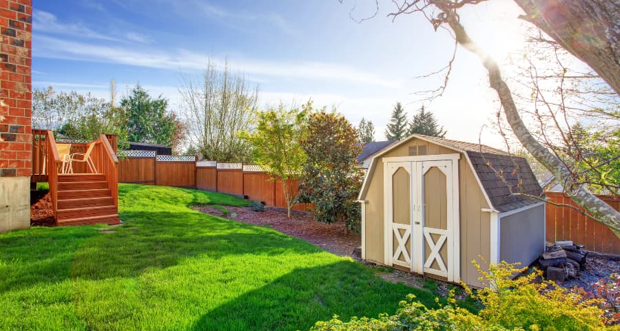 Fenced backyard with storage shed in Grand Rapids